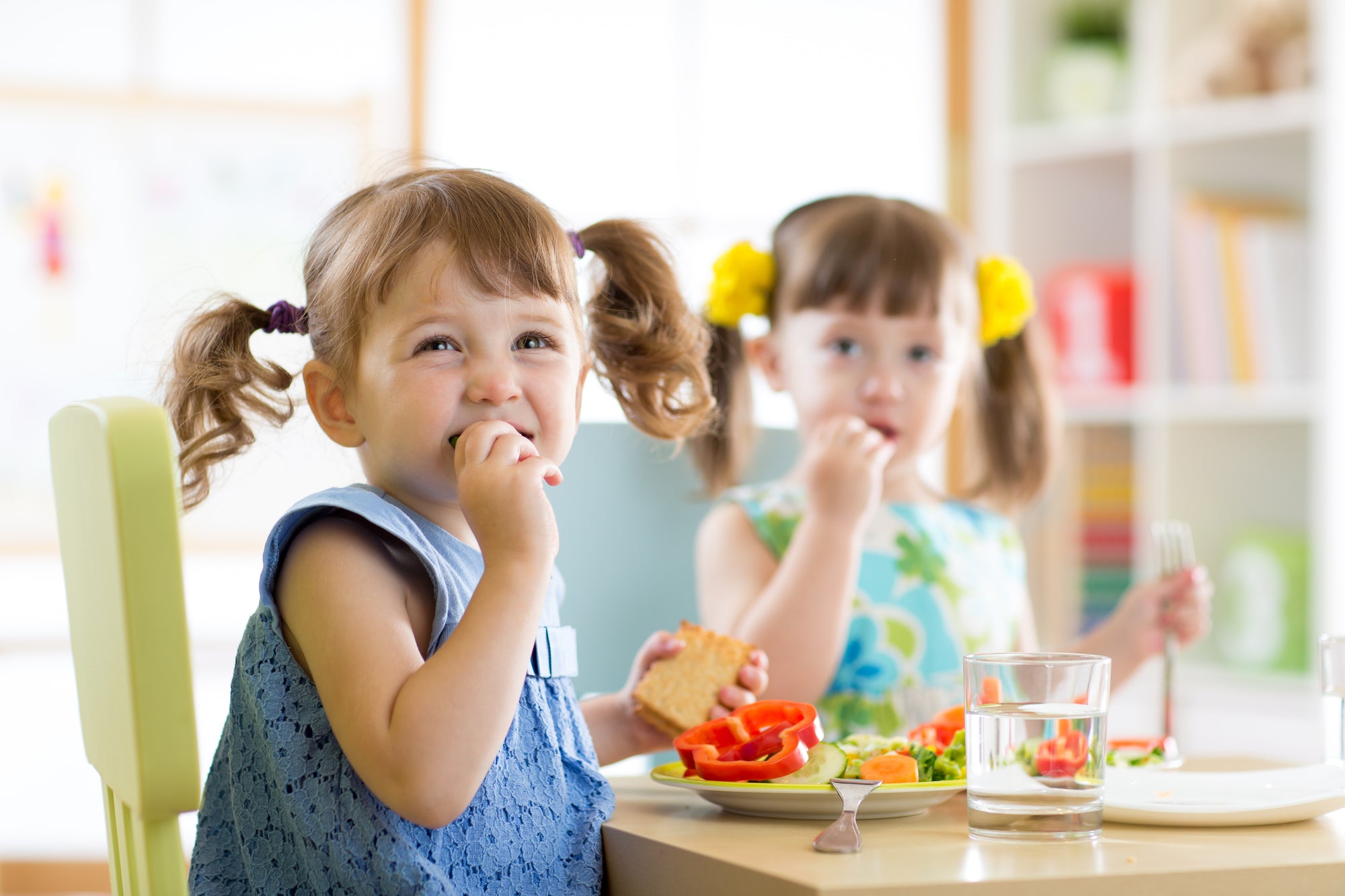 2 young girls eating 