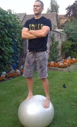 Man Standing On A Large Yoga Ball